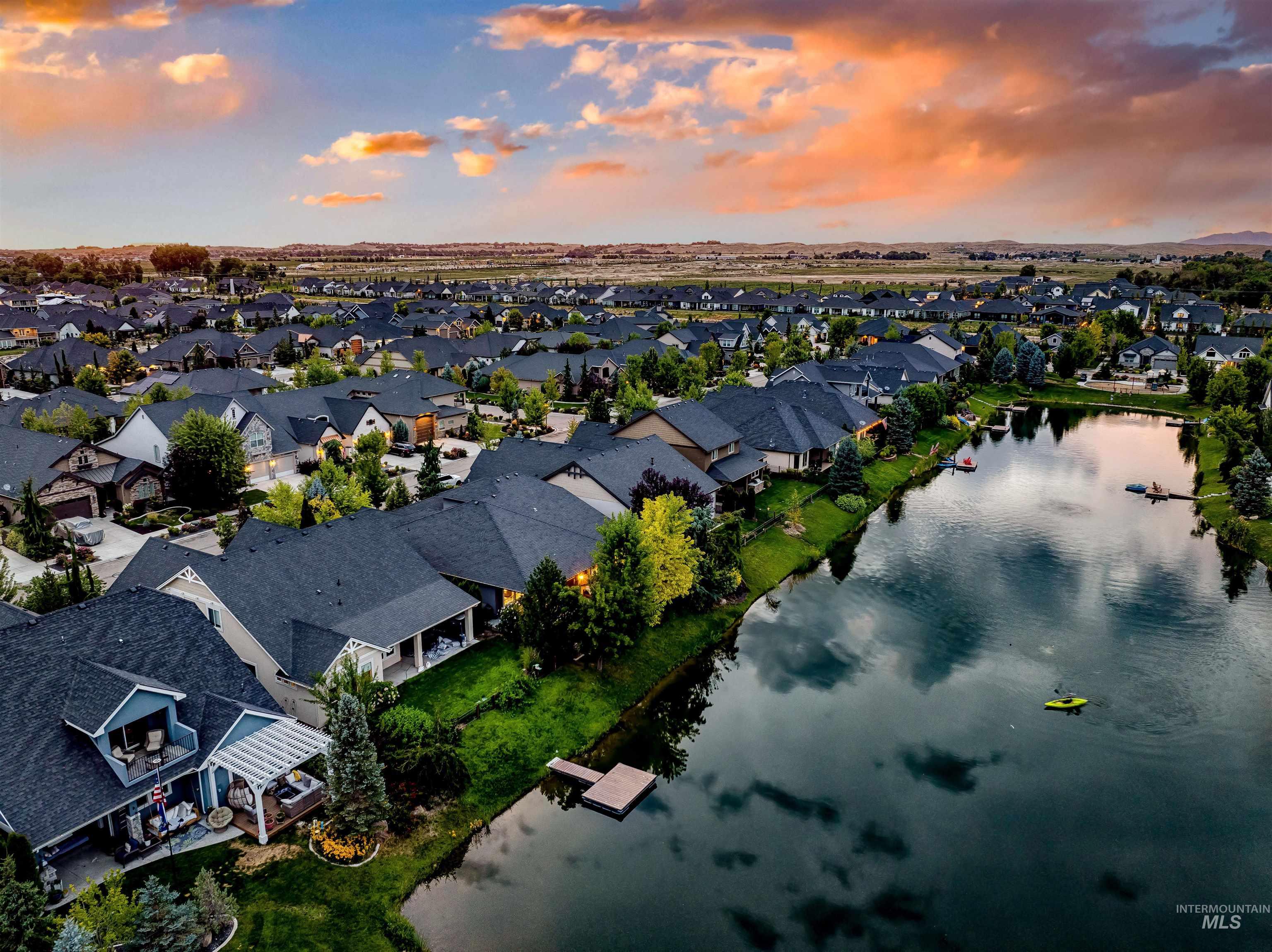Aerial perspective of suburban area with a nearby body of water