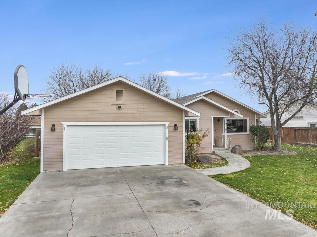 Single story home with concrete driveway