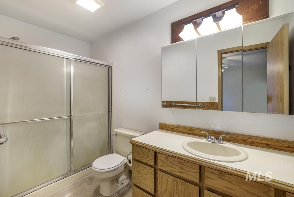 Bathroom with an enclosed shower and vanity