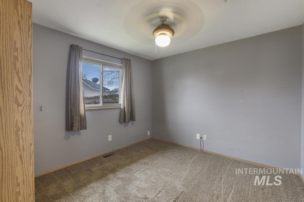 Empty room featuring carpet floors and baseboards