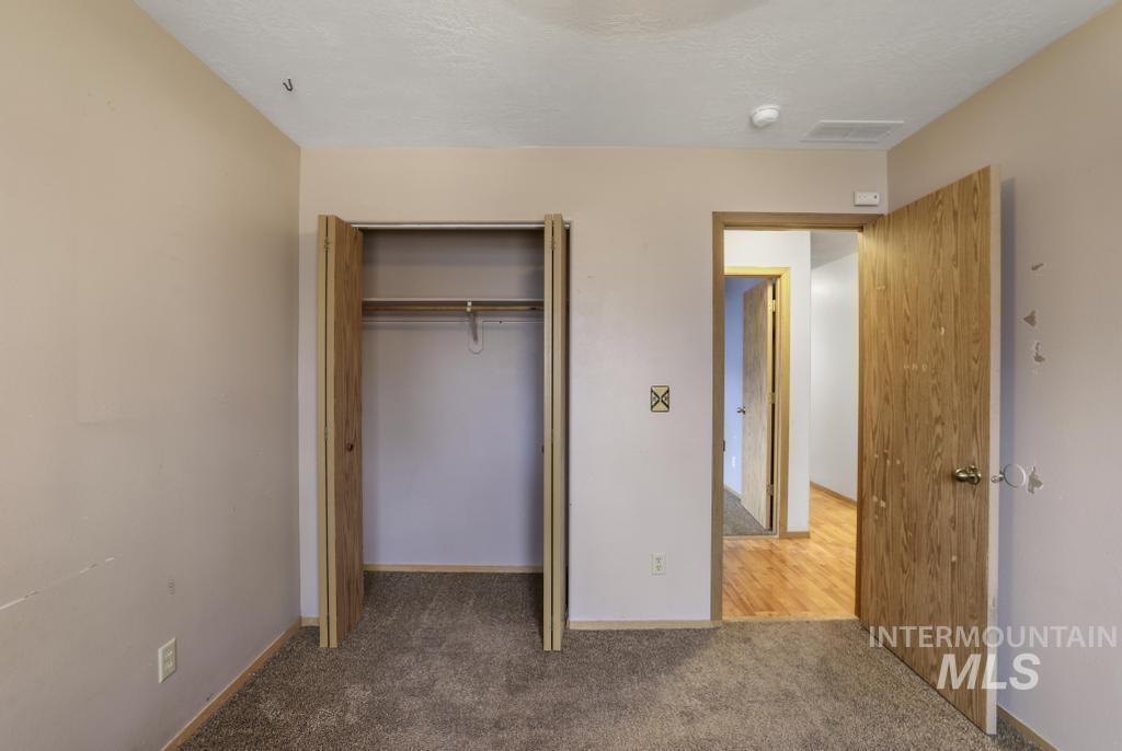 Unfurnished bedroom with carpet and a closet