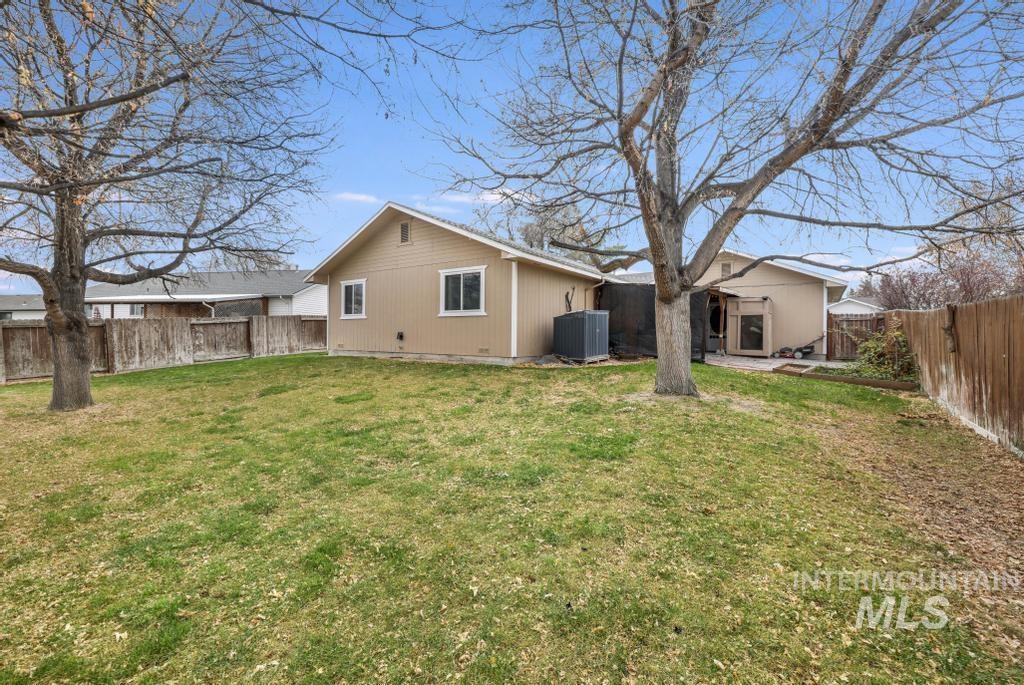 Rear view of property with a fenced backyard and a patio