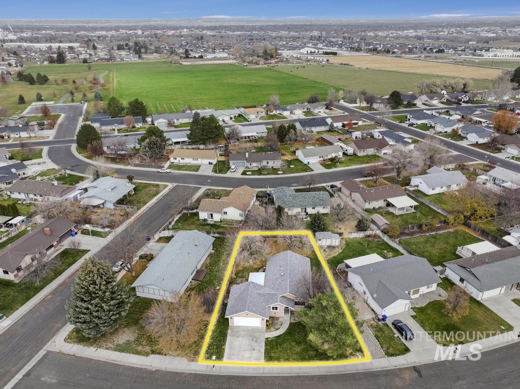 Aerial view of property's location featuring property parcel outlined and nearby suburban area