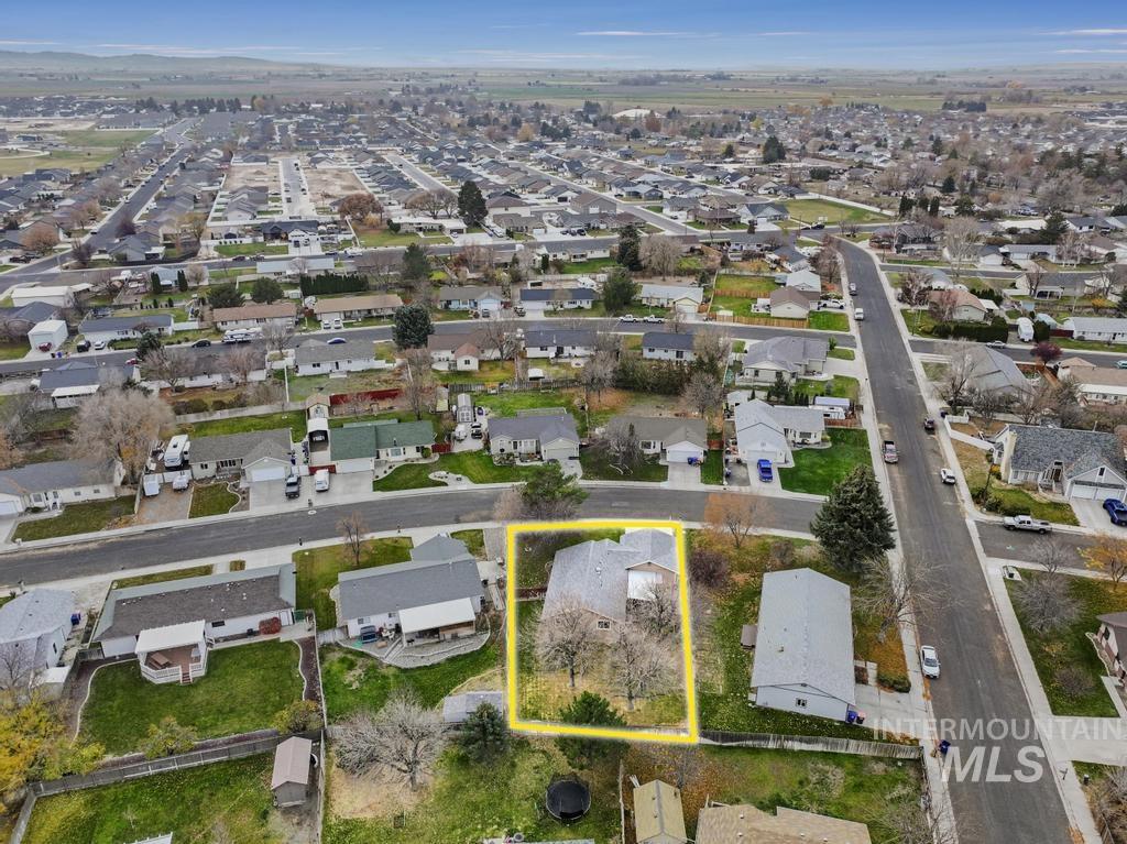 Aerial perspective of suburban area featuring property parcel outlined