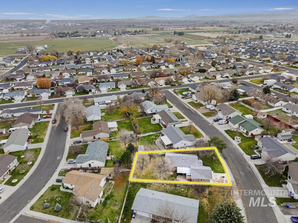 Aerial view of residential area with property parcel outlined