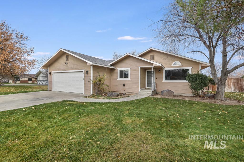 Home featuring driveway and a garage