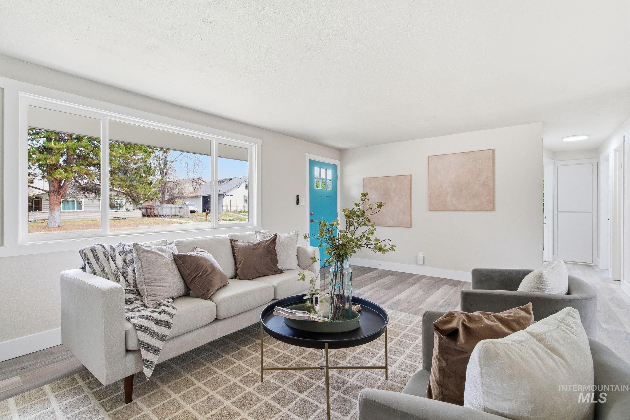Living area featuring baseboards and wood finished floors