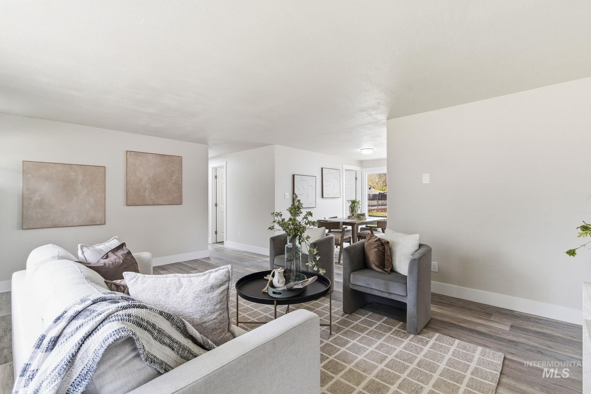 Living area featuring baseboards and wood finished floors