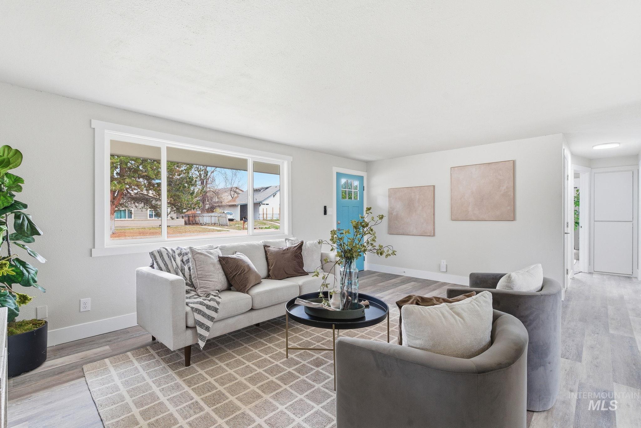 Living area with light wood finished floors and baseboards