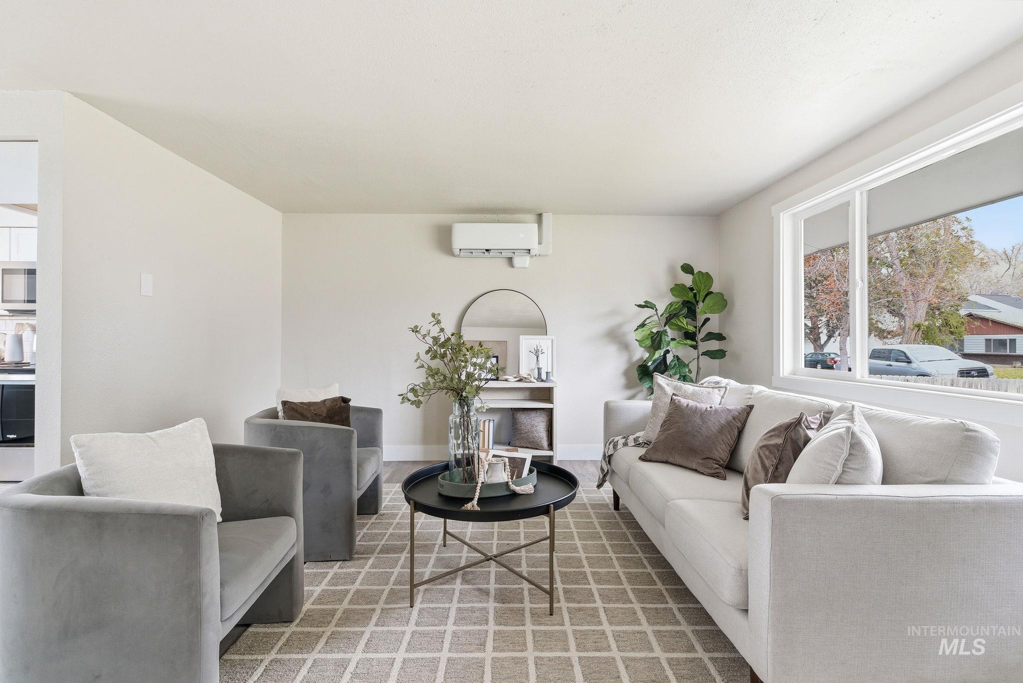 Living area with healthy amount of natural light and a wall mounted air conditioner