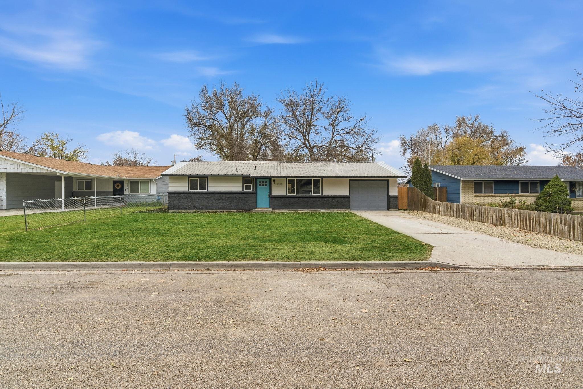 Ranch-style house with driveway, brick siding, and a garage