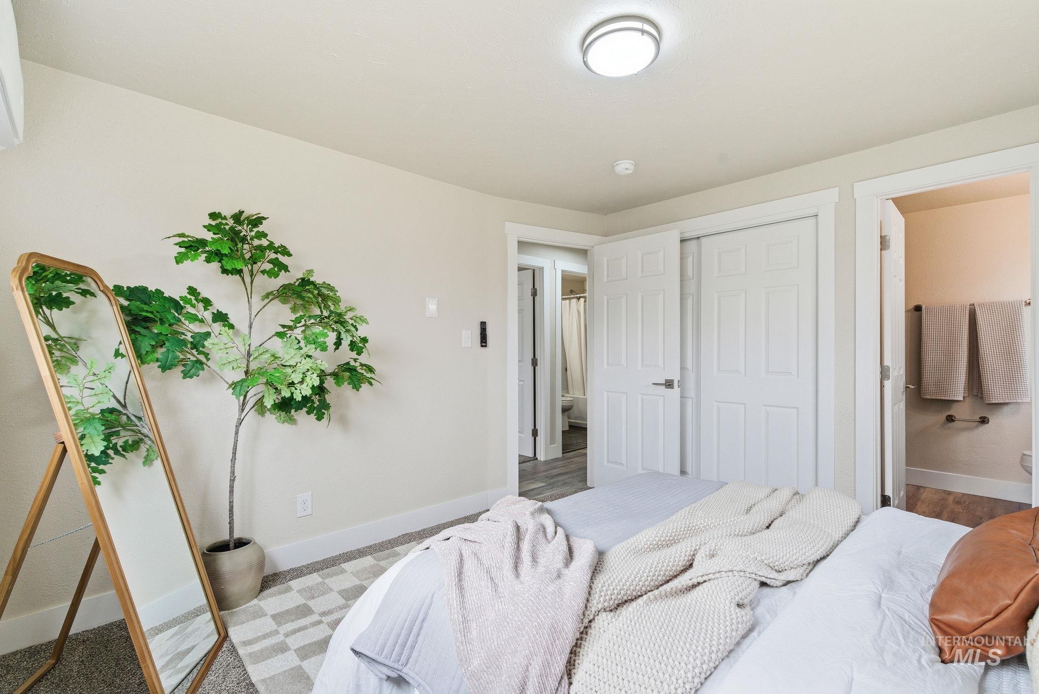 Bedroom featuring ensuite bath and a closet
