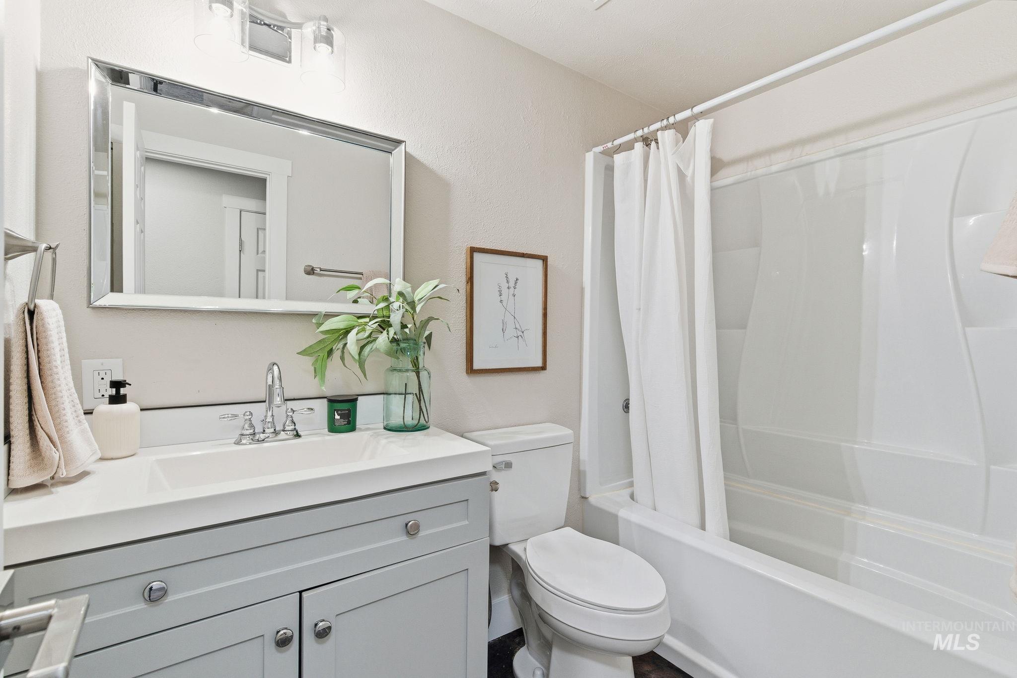Full bathroom featuring shower / tub combo with curtain and vanity
