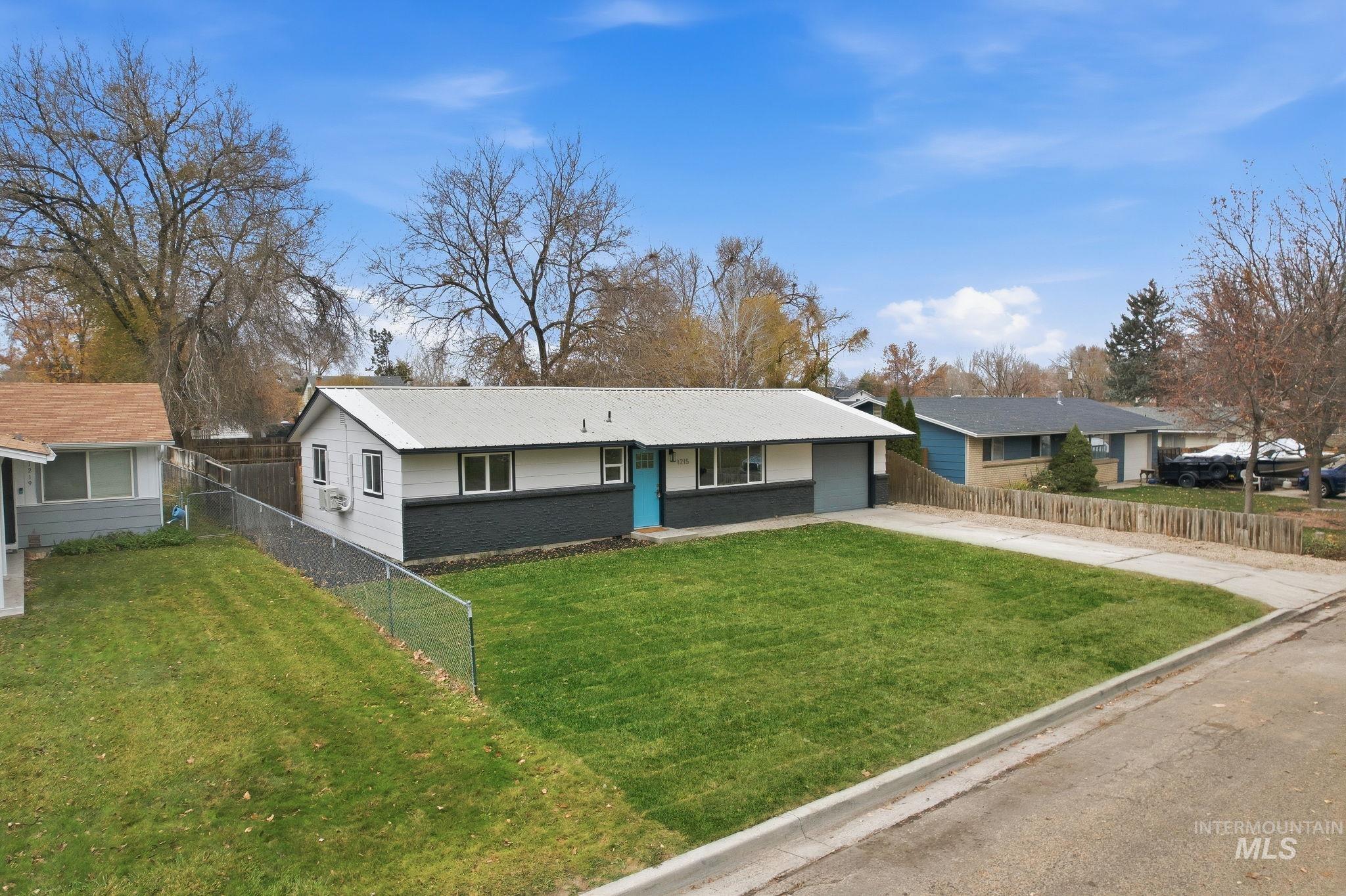 Ranch-style house with concrete driveway, brick siding, and a garage