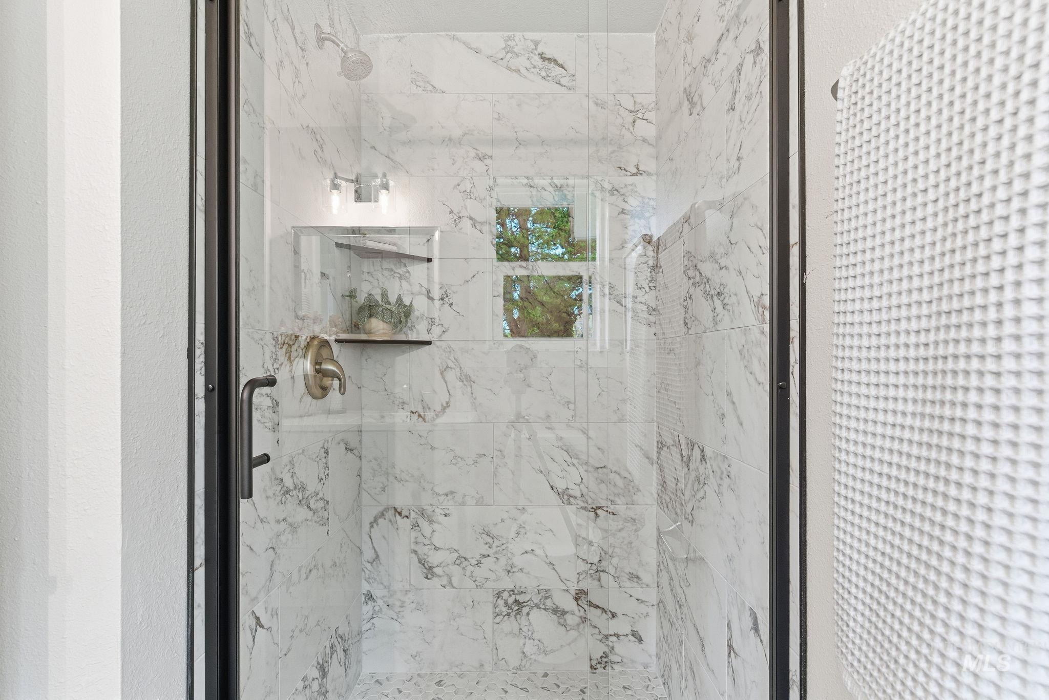 Full bathroom featuring a marble finish shower