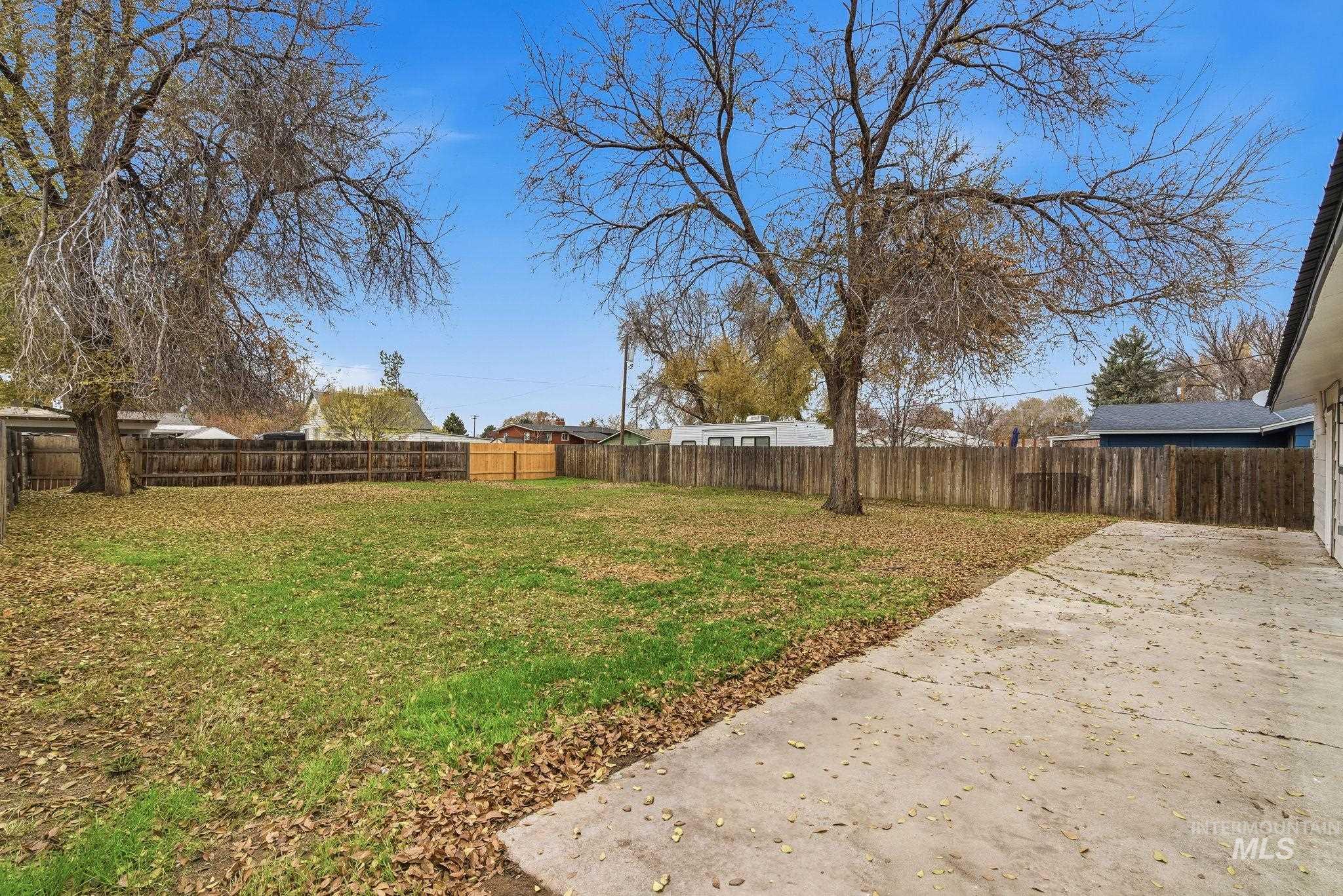 Fenced backyard featuring a patio