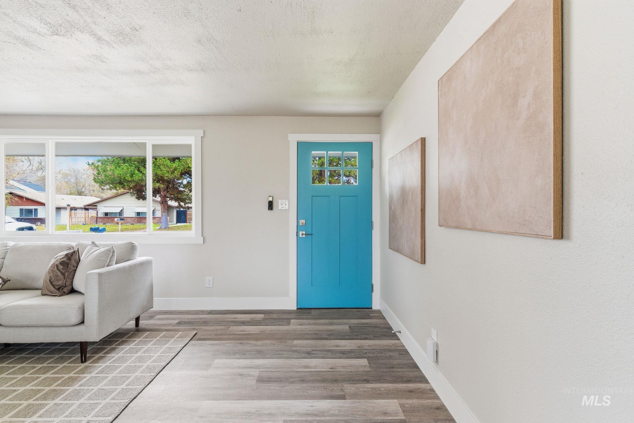 Entrance foyer featuring light wood-style floors and a textured ceiling