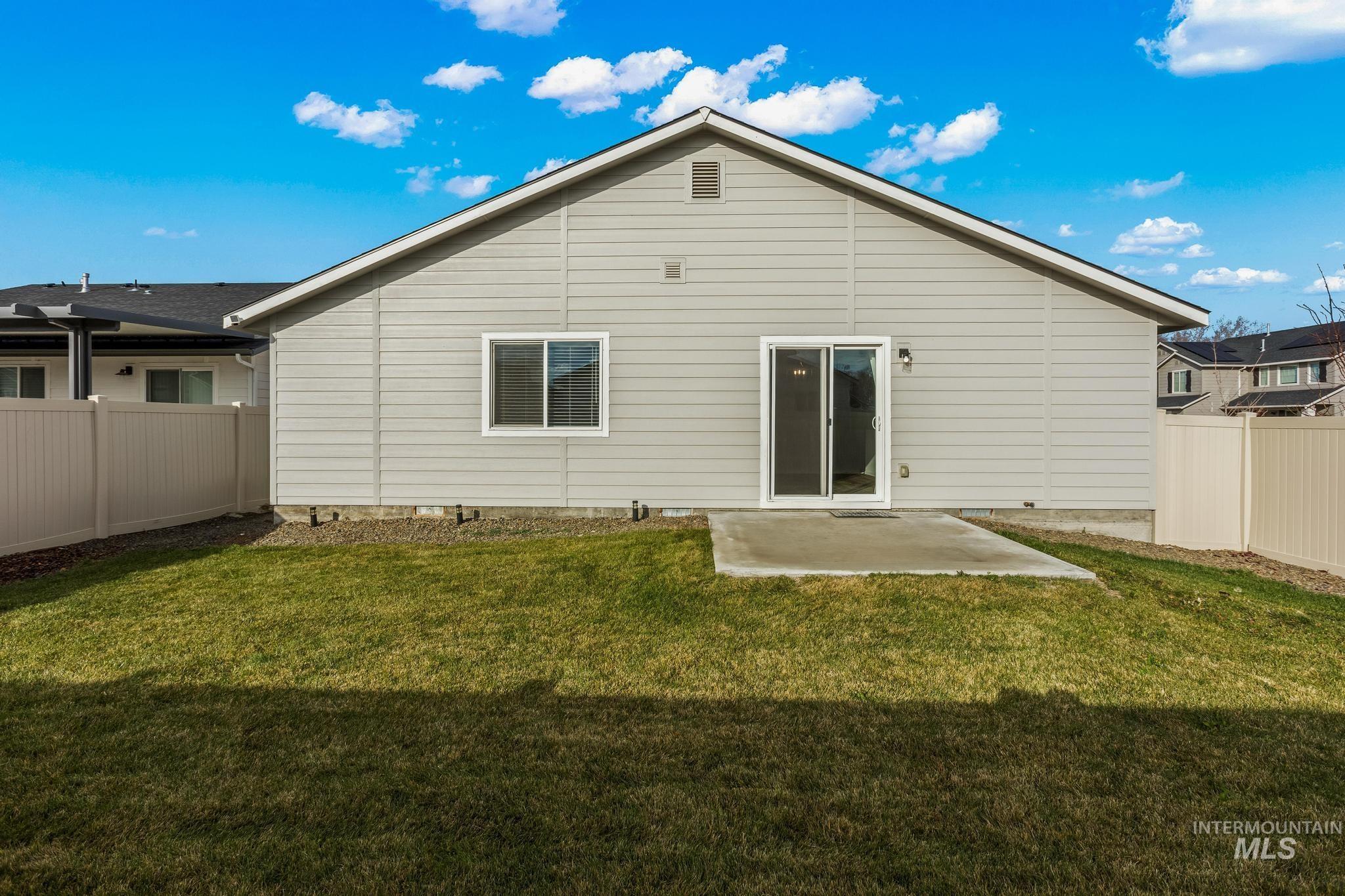 Rear view of property featuring a fenced backyard and a patio area