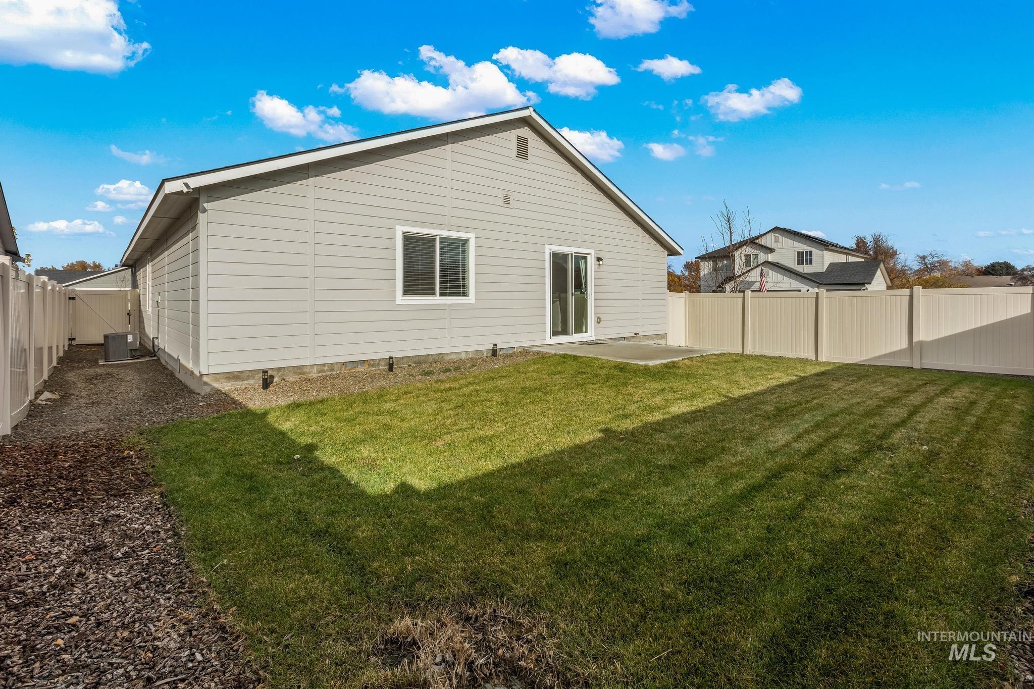 Rear view of property featuring a patio area and a fenced backyard