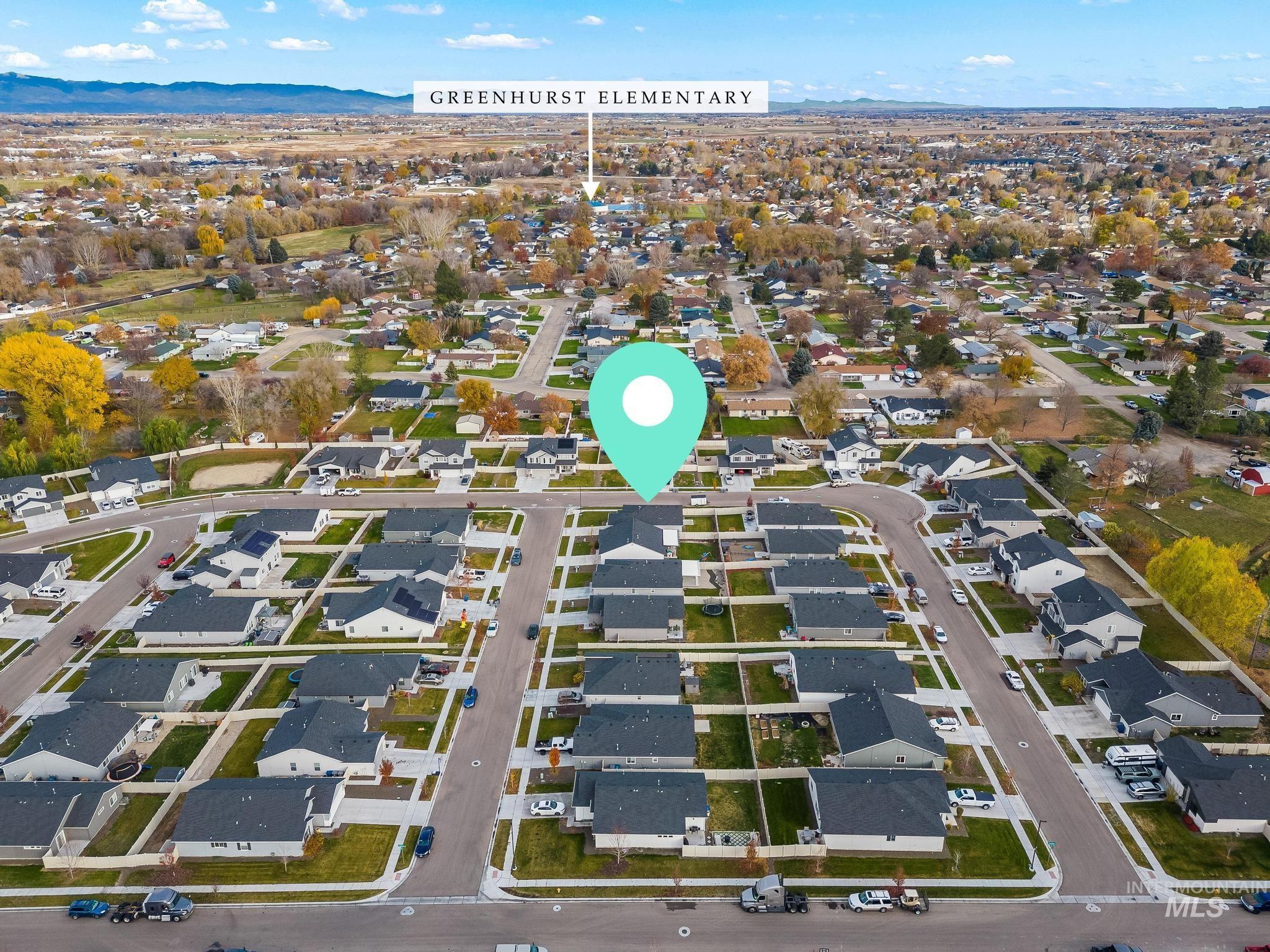 View of property location featuring nearby suburban area and a mountainous background