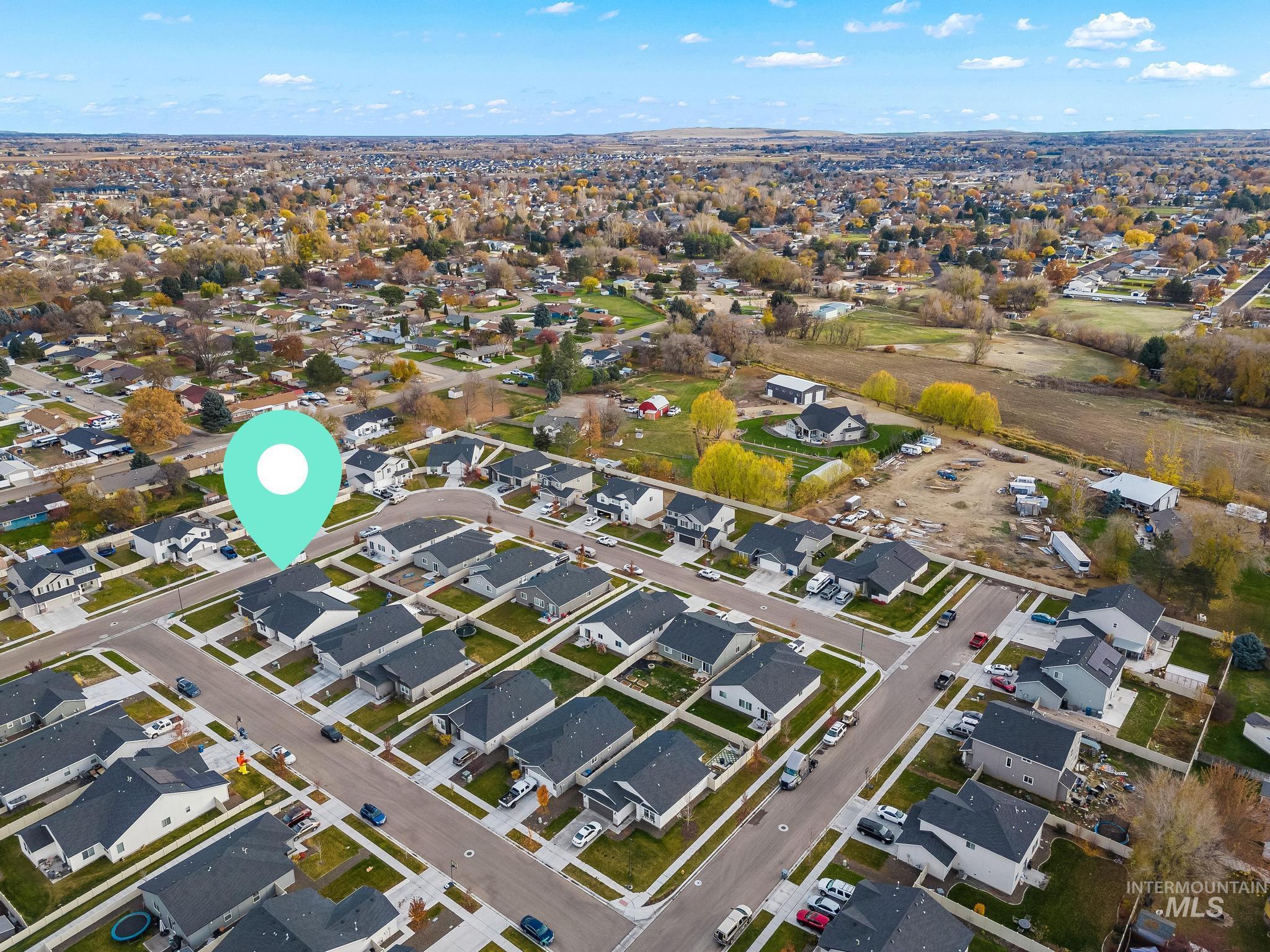 Aerial view of property's location featuring nearby suburban area