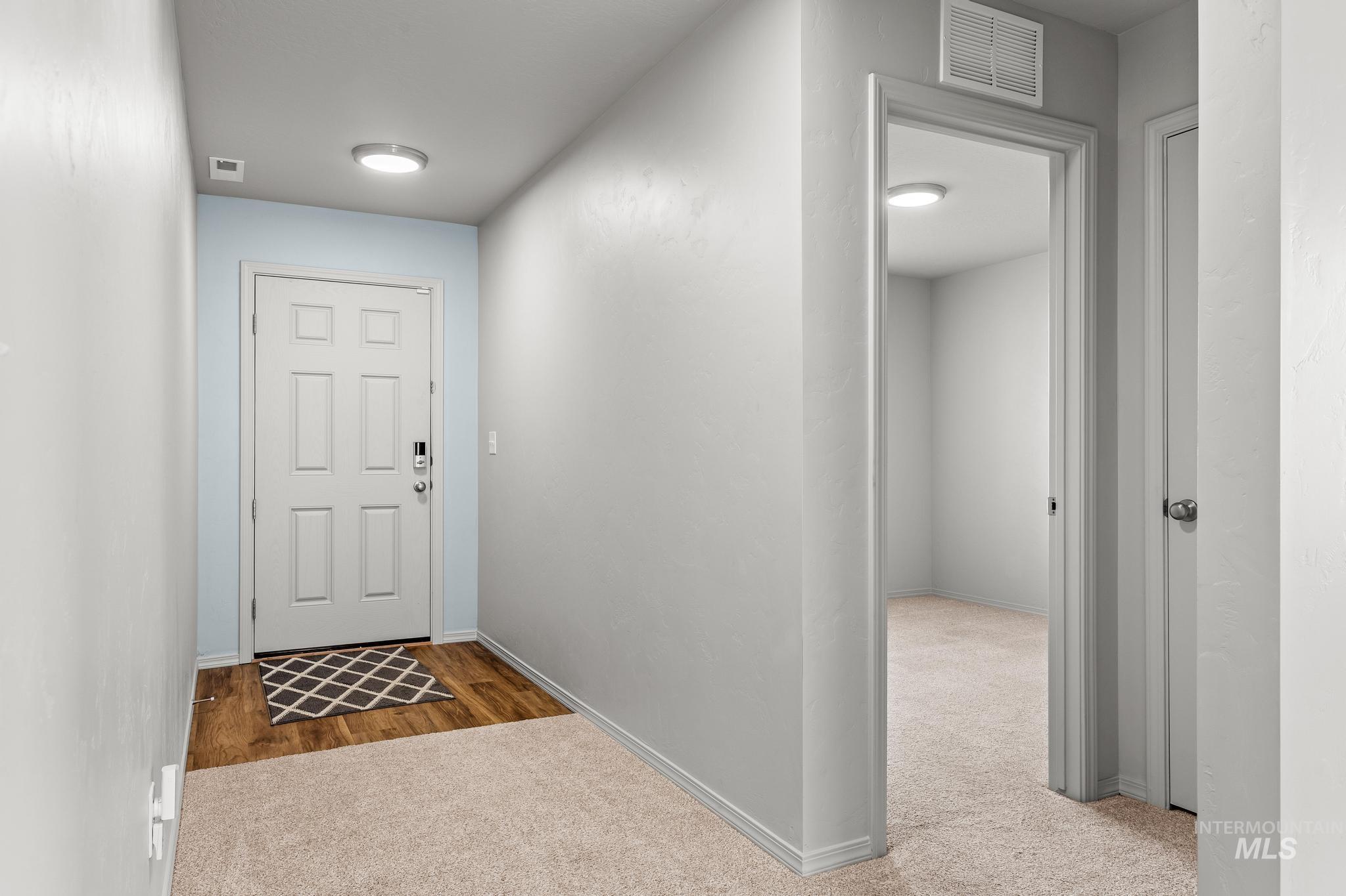 Entryway with carpet and wood finished floors