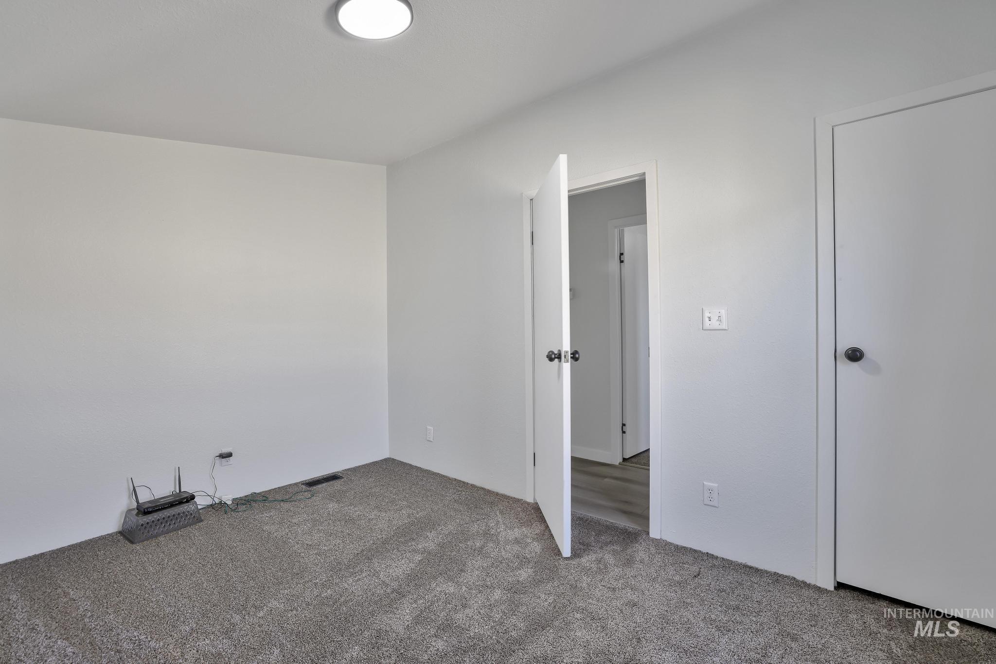 Unfurnished bedroom with carpet flooring