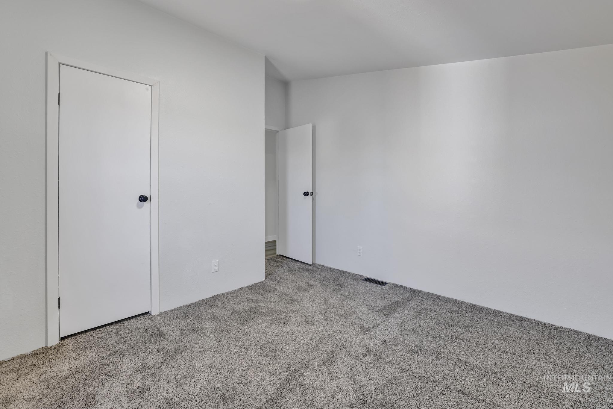 Unfurnished bedroom with carpet flooring