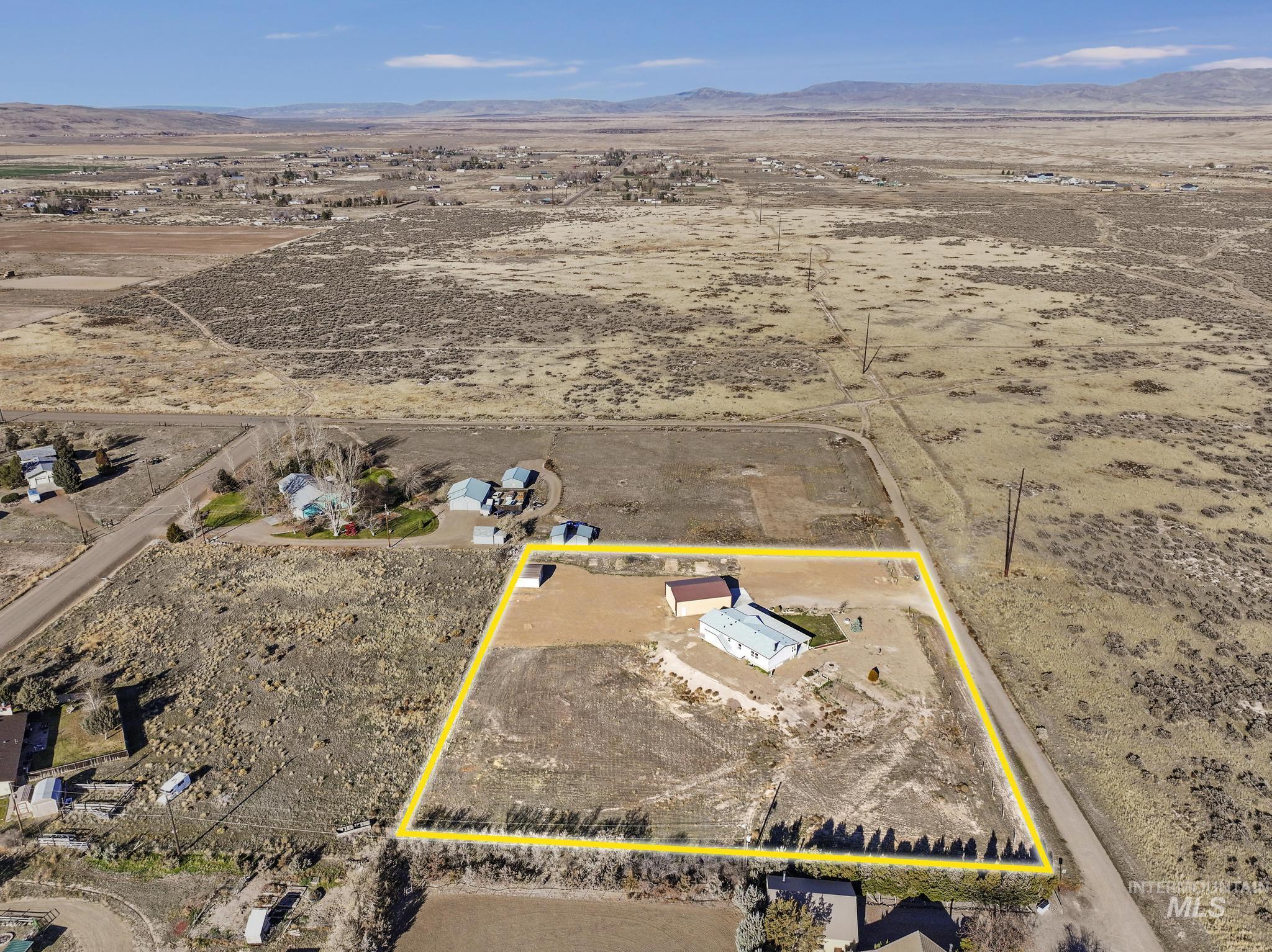 Overview of rural landscape featuring property boundaries highlighted and mountains