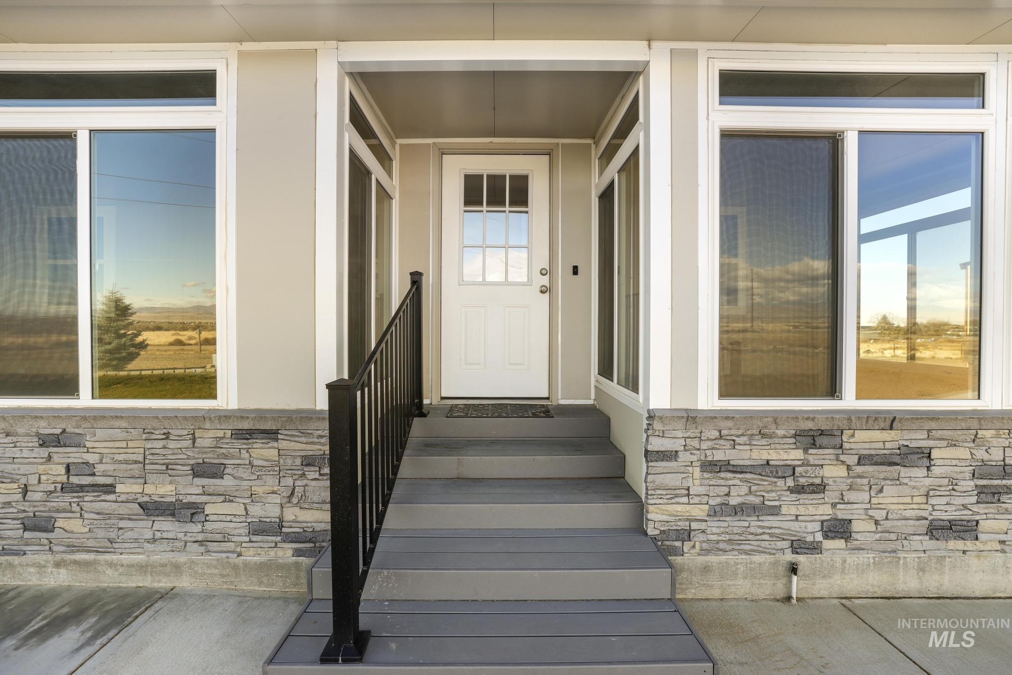 Doorway to property with stone siding