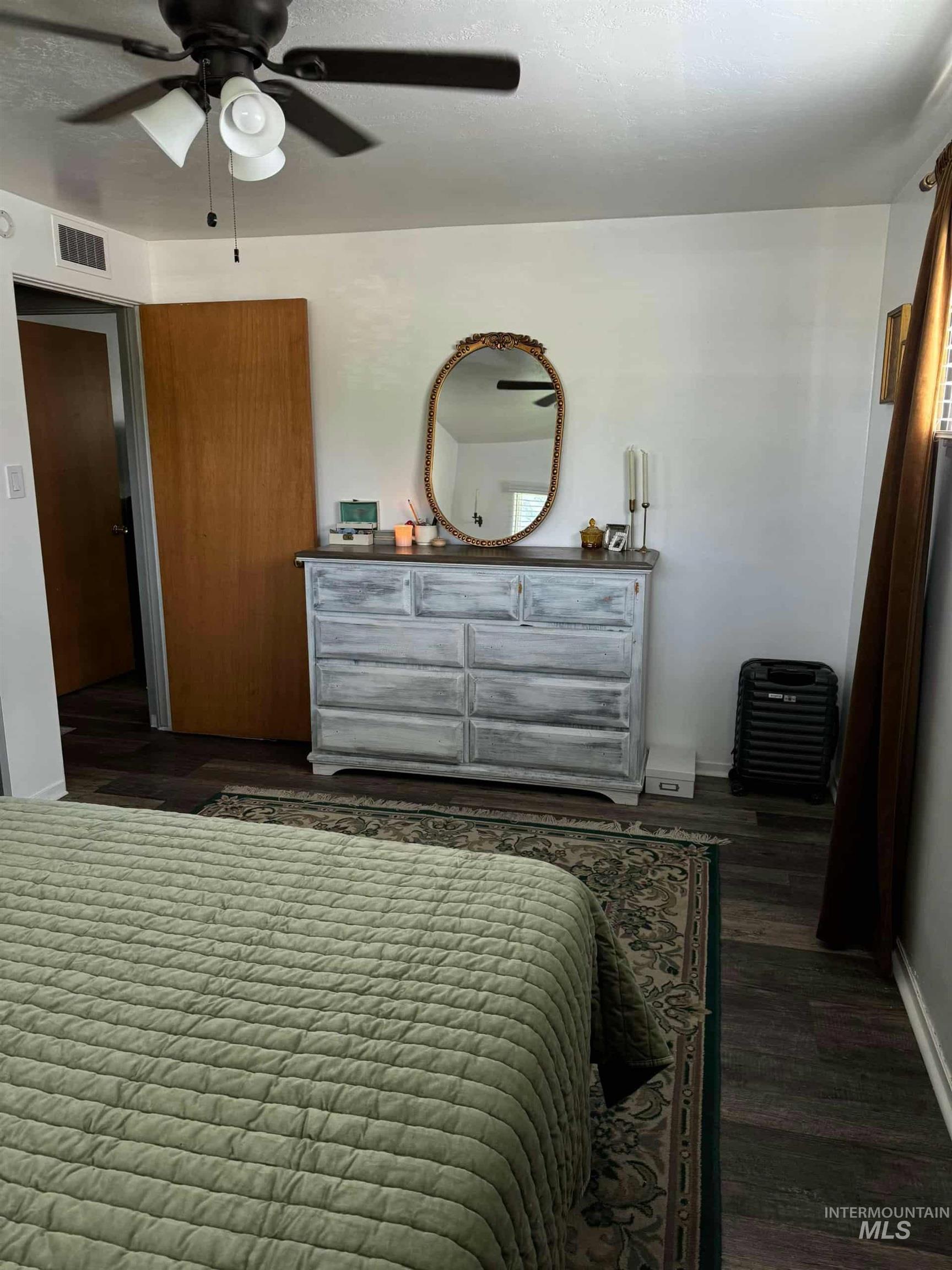 Bedroom featuring a ceiling fan and baseboards