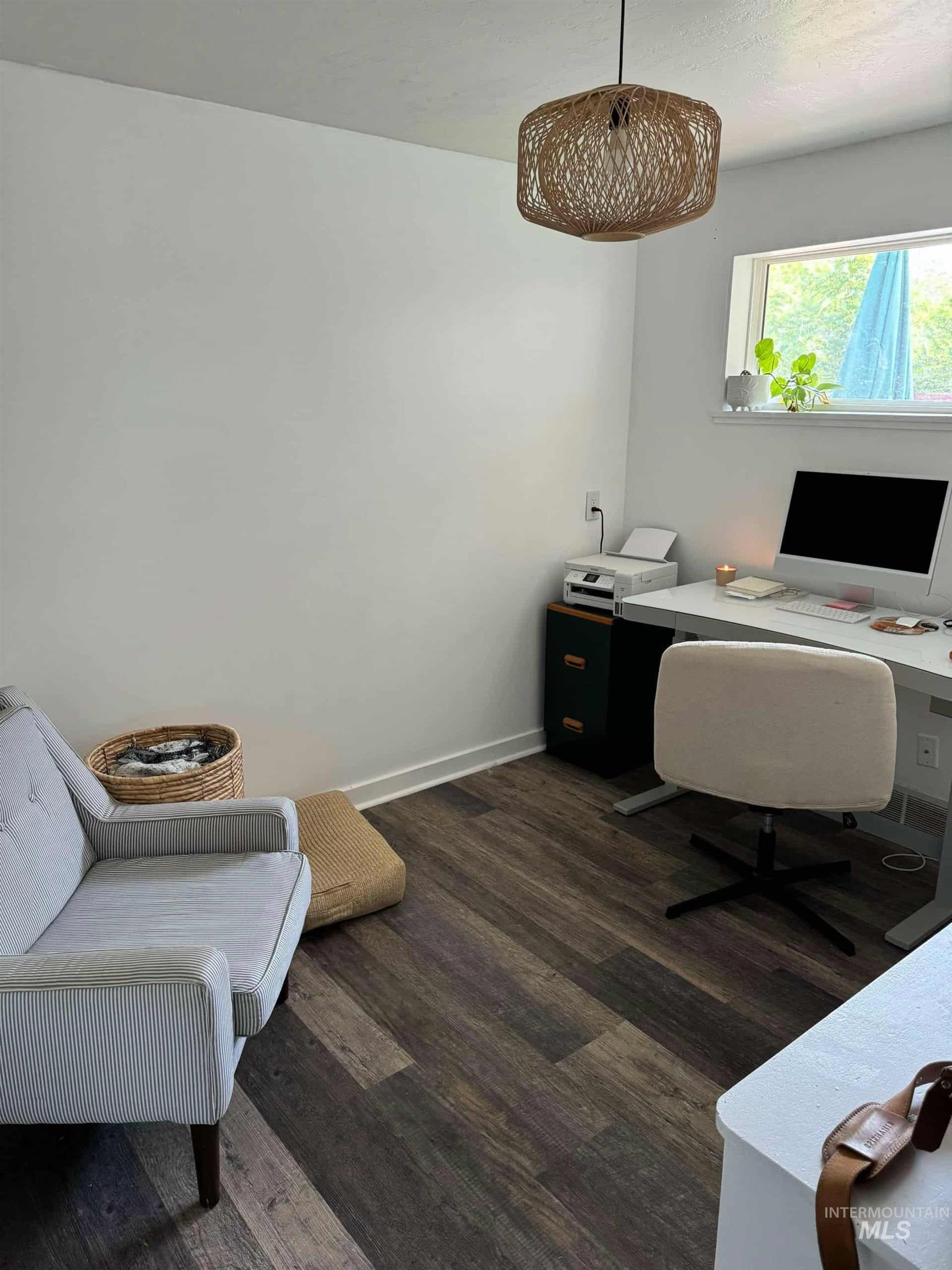 Office area featuring dark wood finished floors and baseboards