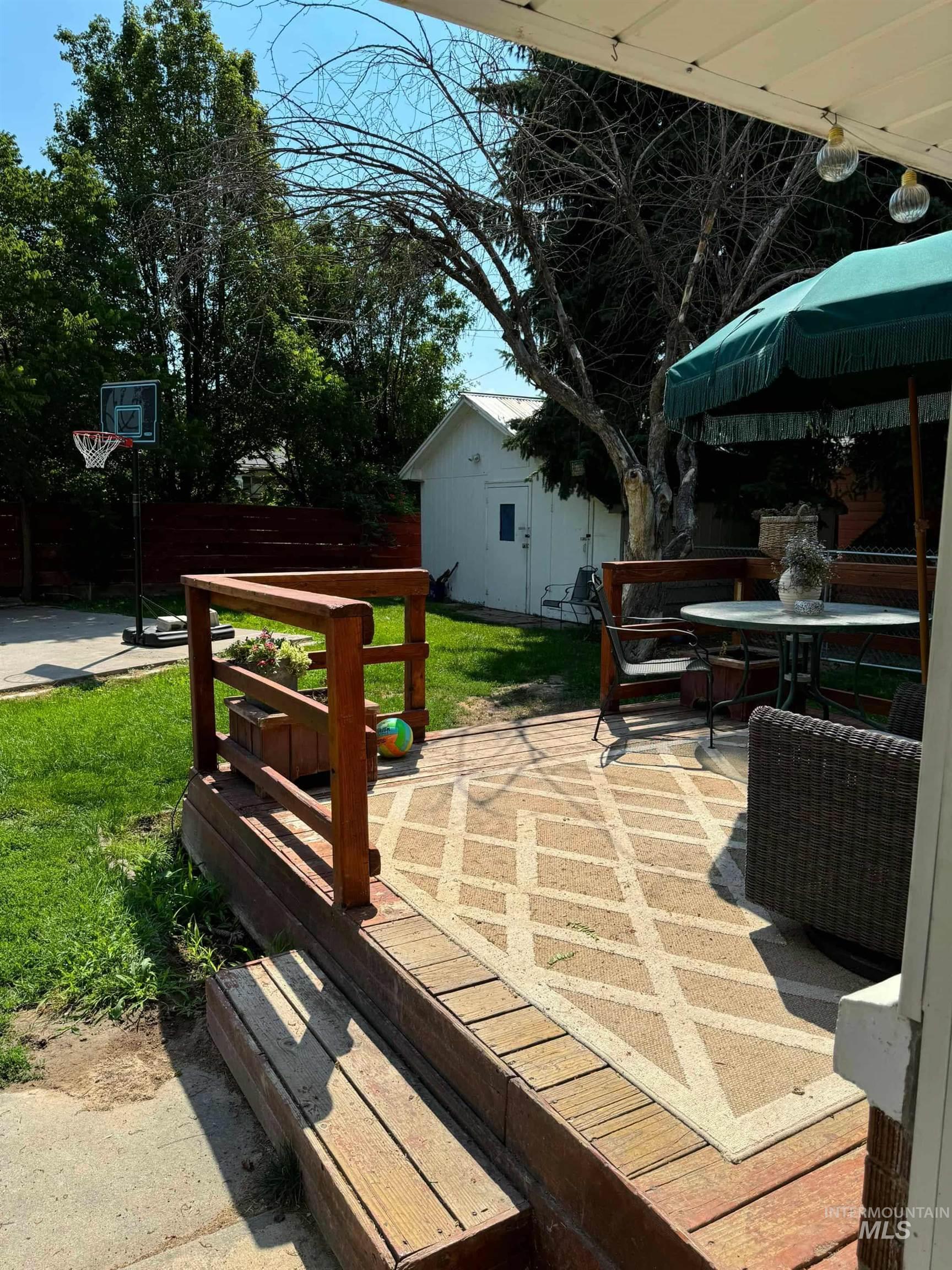 View of patio / terrace featuring outdoor dining area and an outbuilding