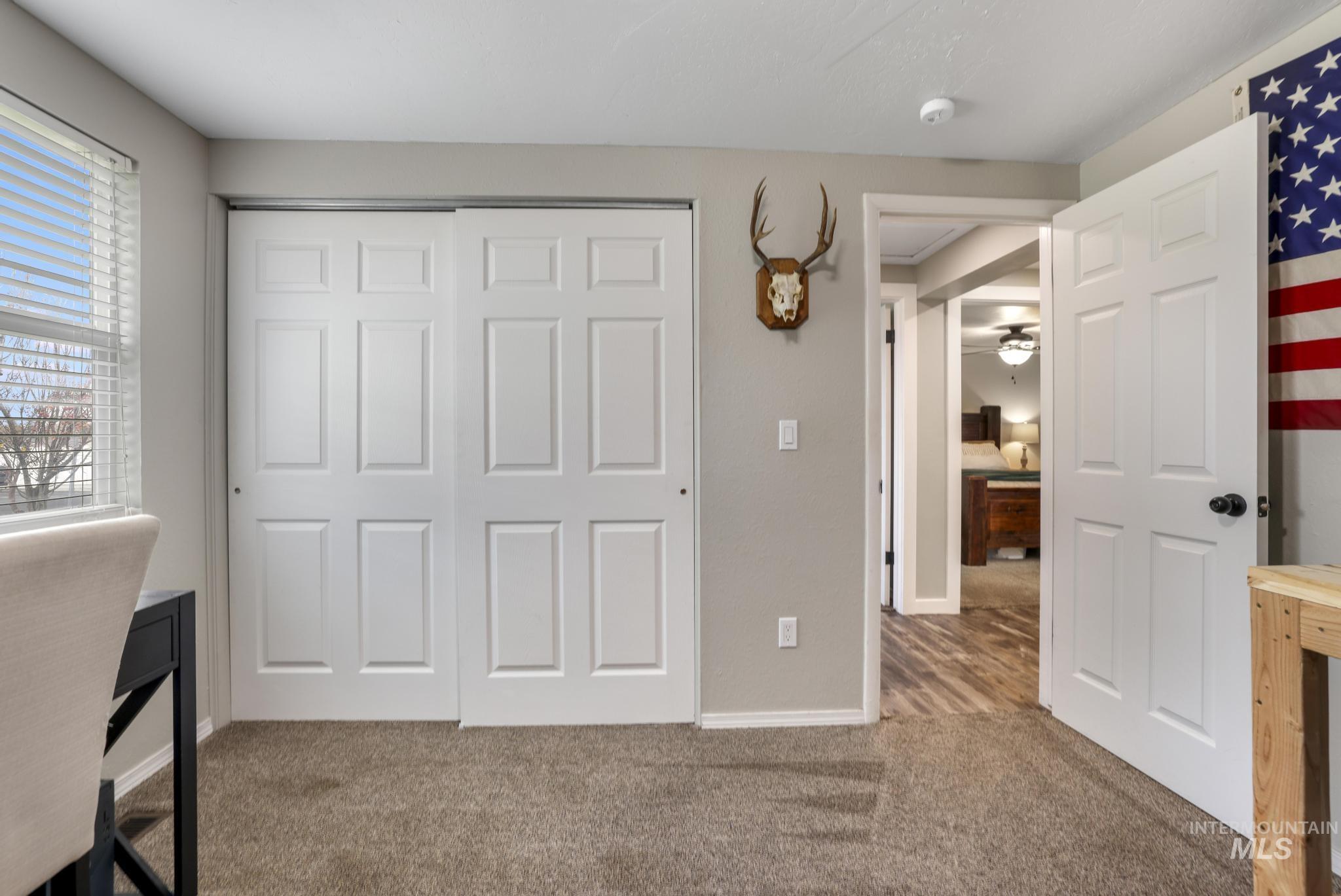 Unfurnished office with light carpet and baseboards