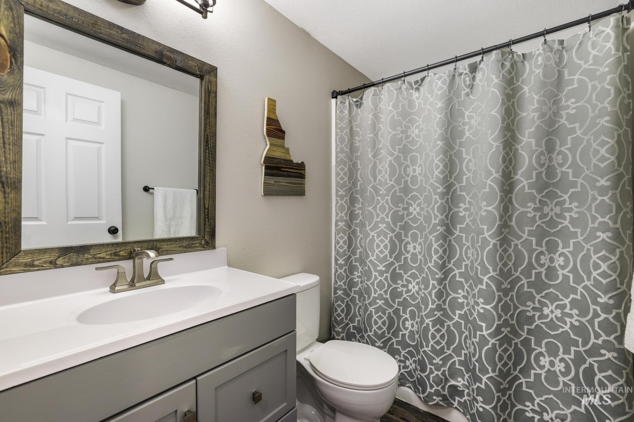 Bathroom featuring vanity and curtained shower