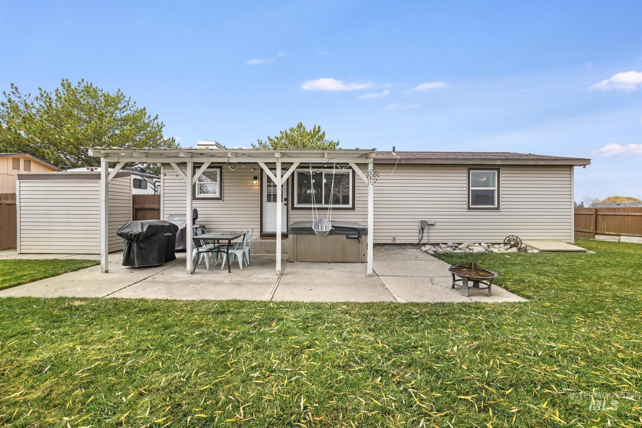 Back of property featuring a patio and a fire pit