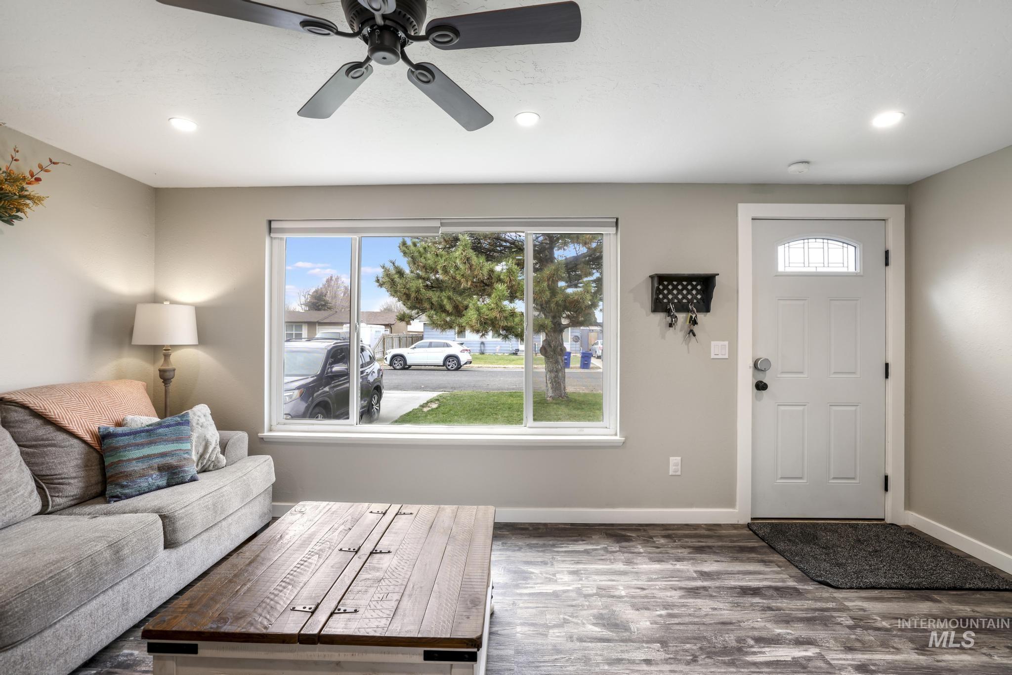 Living area featuring wood finished floors, recessed lighting, and ceiling fan