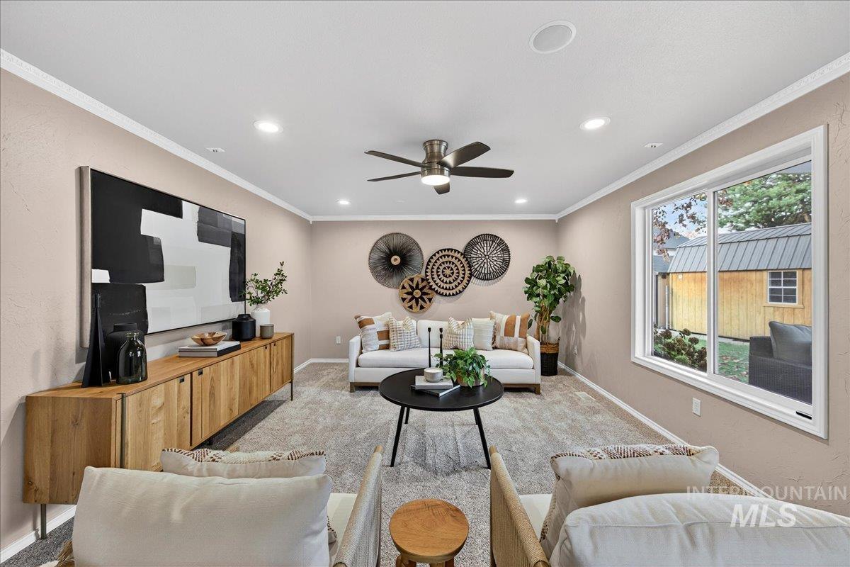 Living area with crown molding, carpet floors, recessed lighting, and ceiling fan