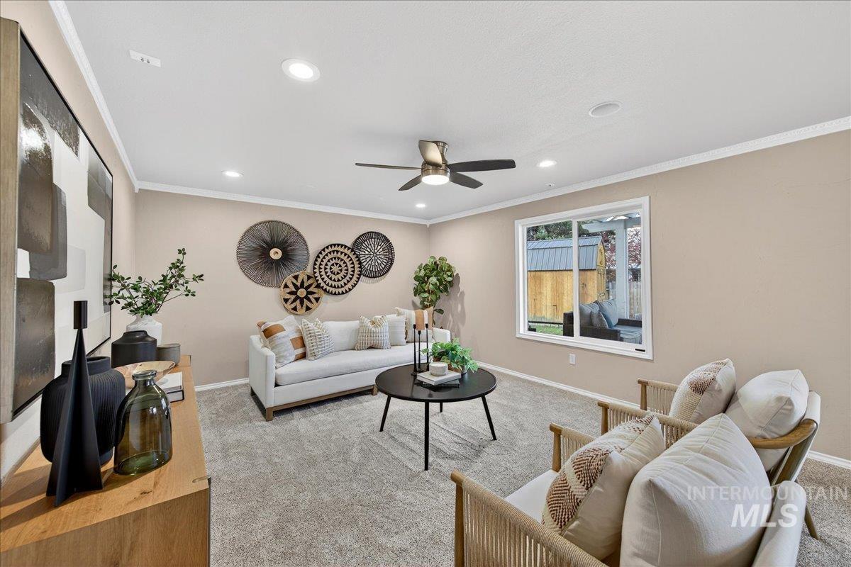 Living room with ornamental molding, recessed lighting, and a ceiling fan