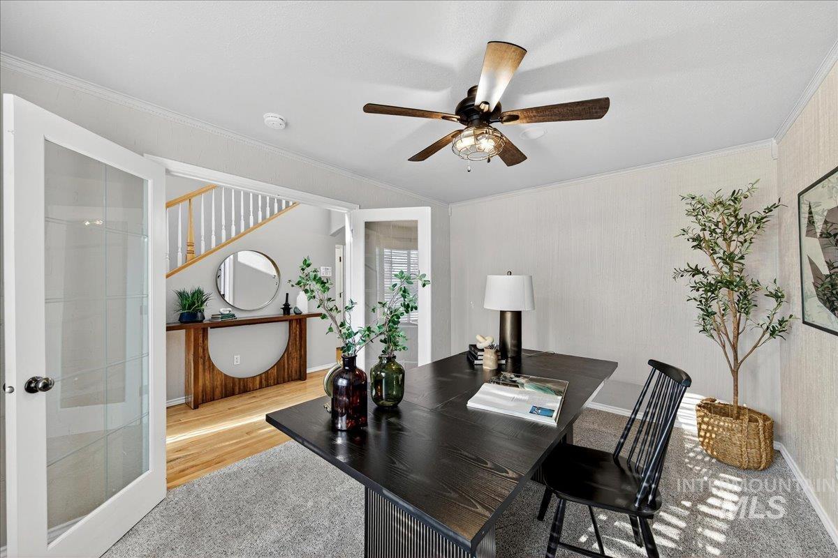 Office area featuring crown molding, a ceiling fan, light wood-type flooring, and french doors