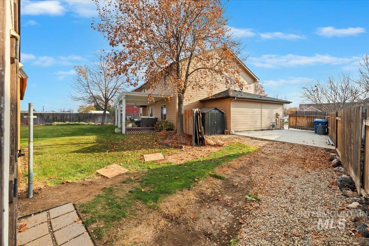 Back of property with a fenced backyard and a patio