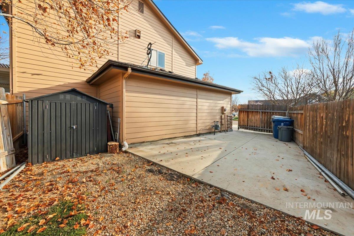 View of home's exterior with a patio and a shed