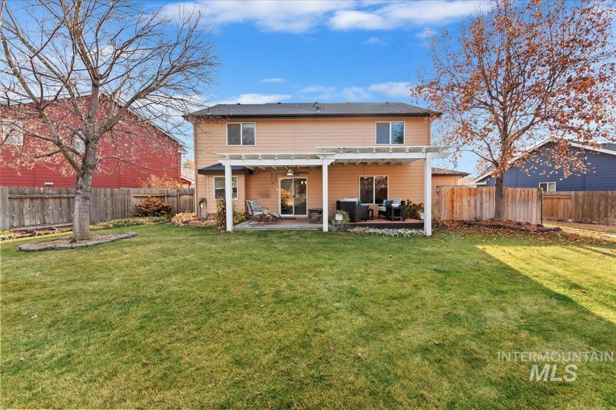 Rear view of house featuring a patio and a fenced backyard