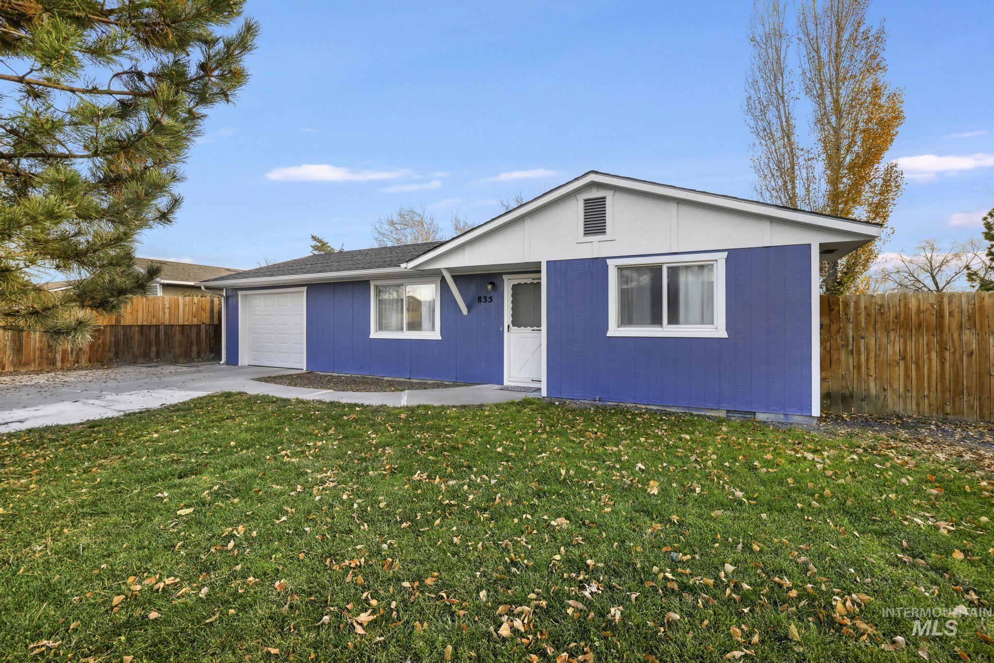 Ranch-style home featuring driveway and an attached garage