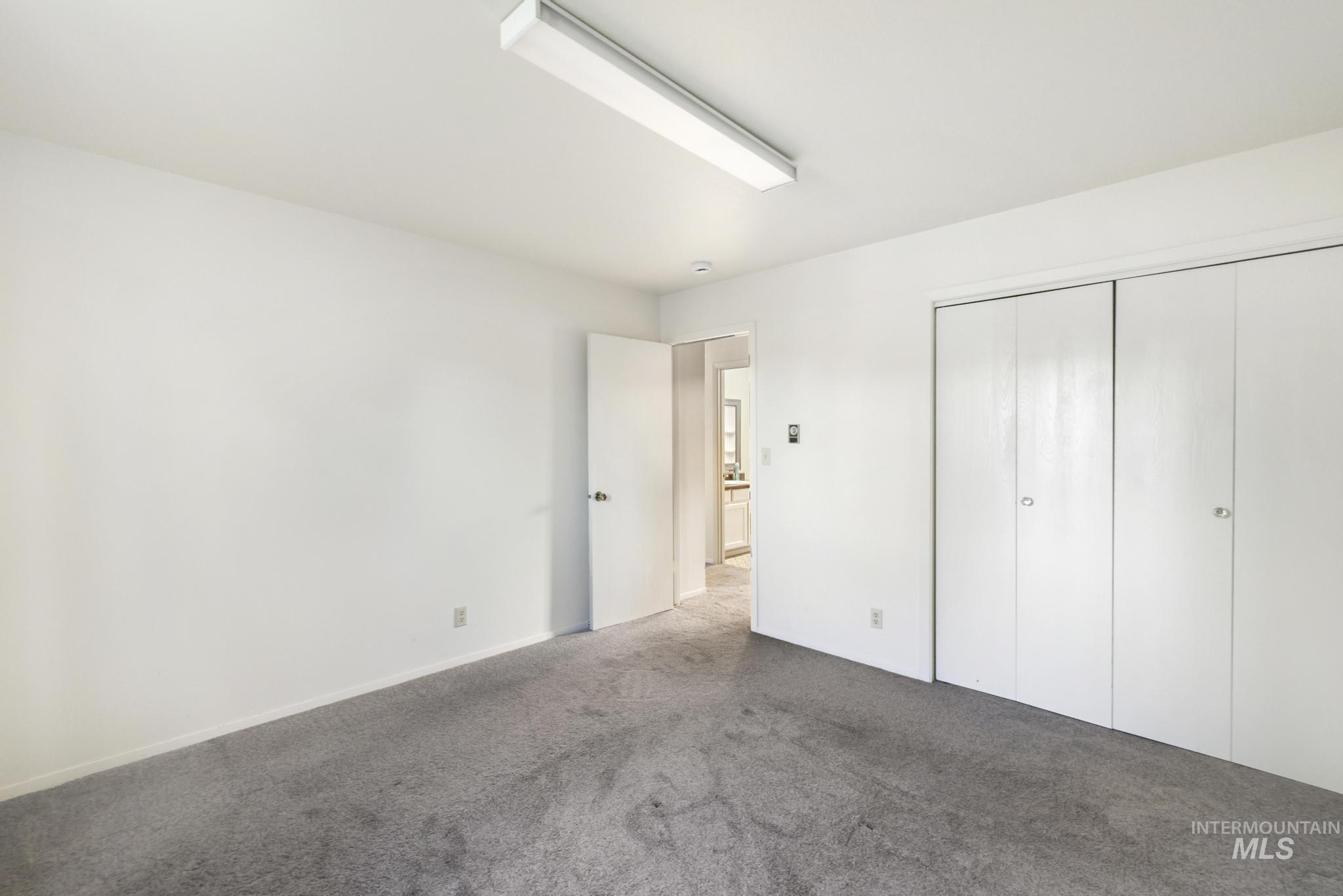 Unfurnished bedroom with carpet flooring and a closet