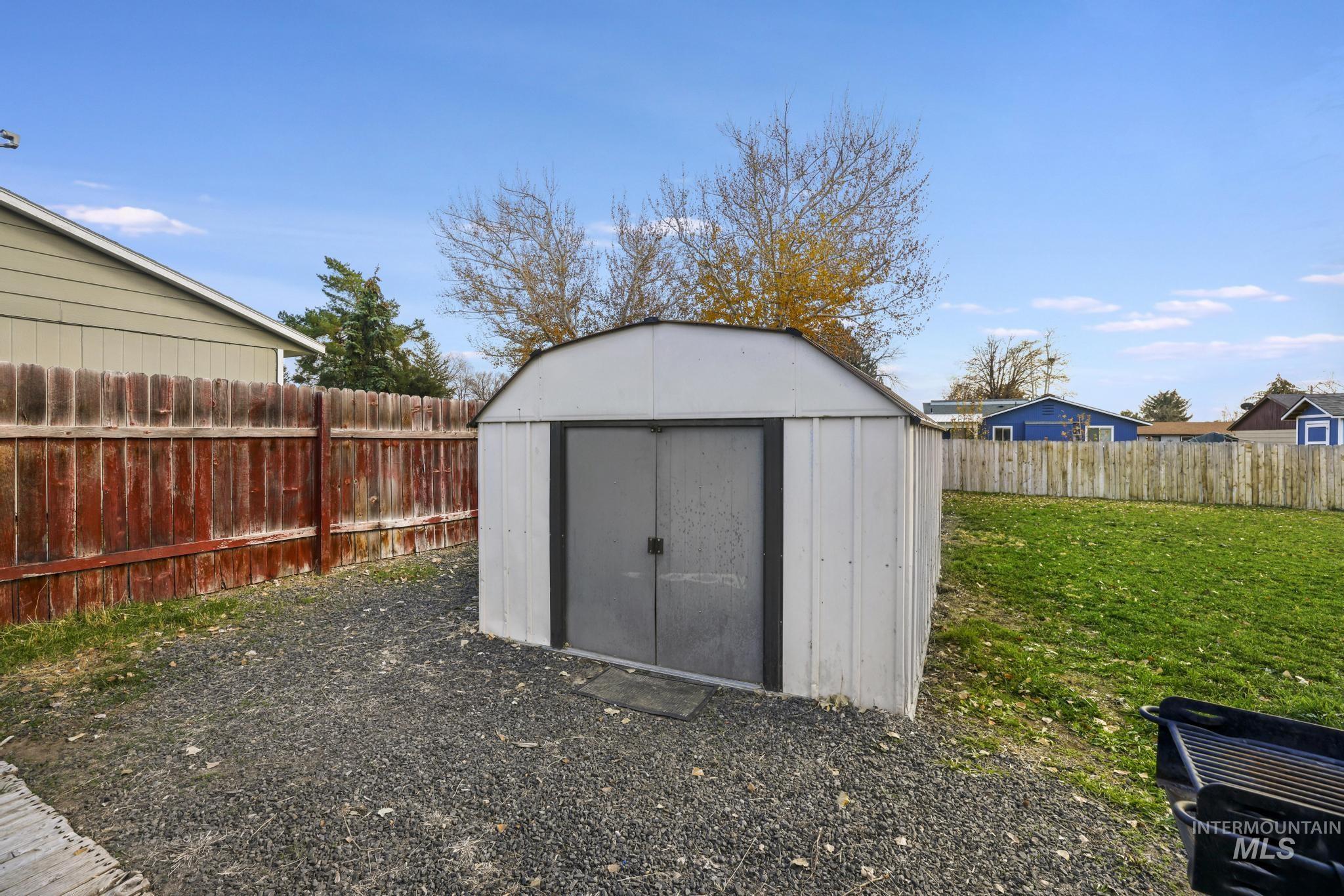 View of shed with a fenced backyard