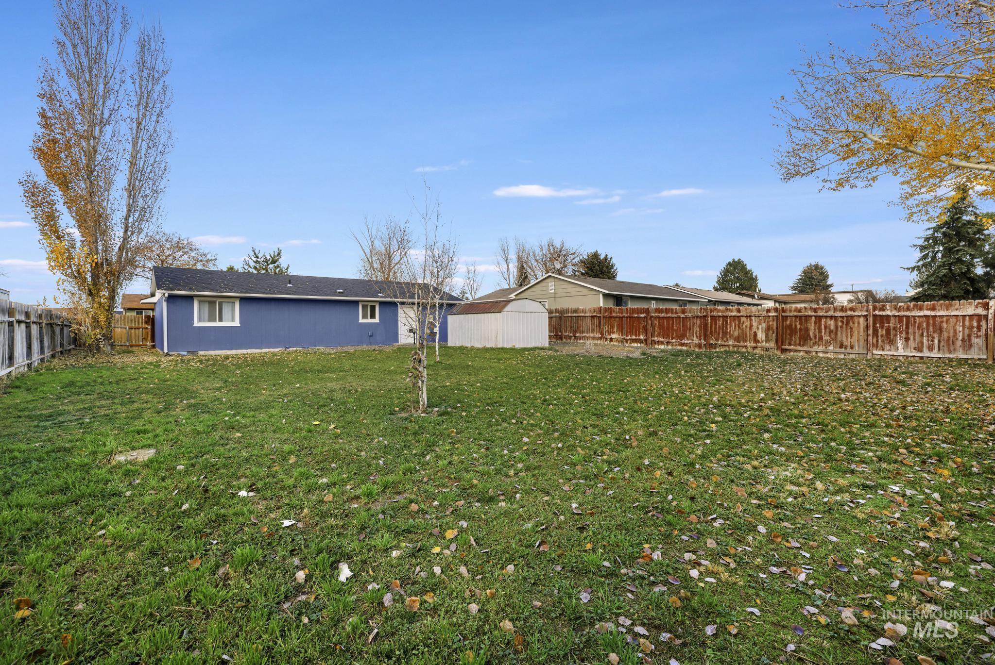 Rear view of property featuring a fenced backyard