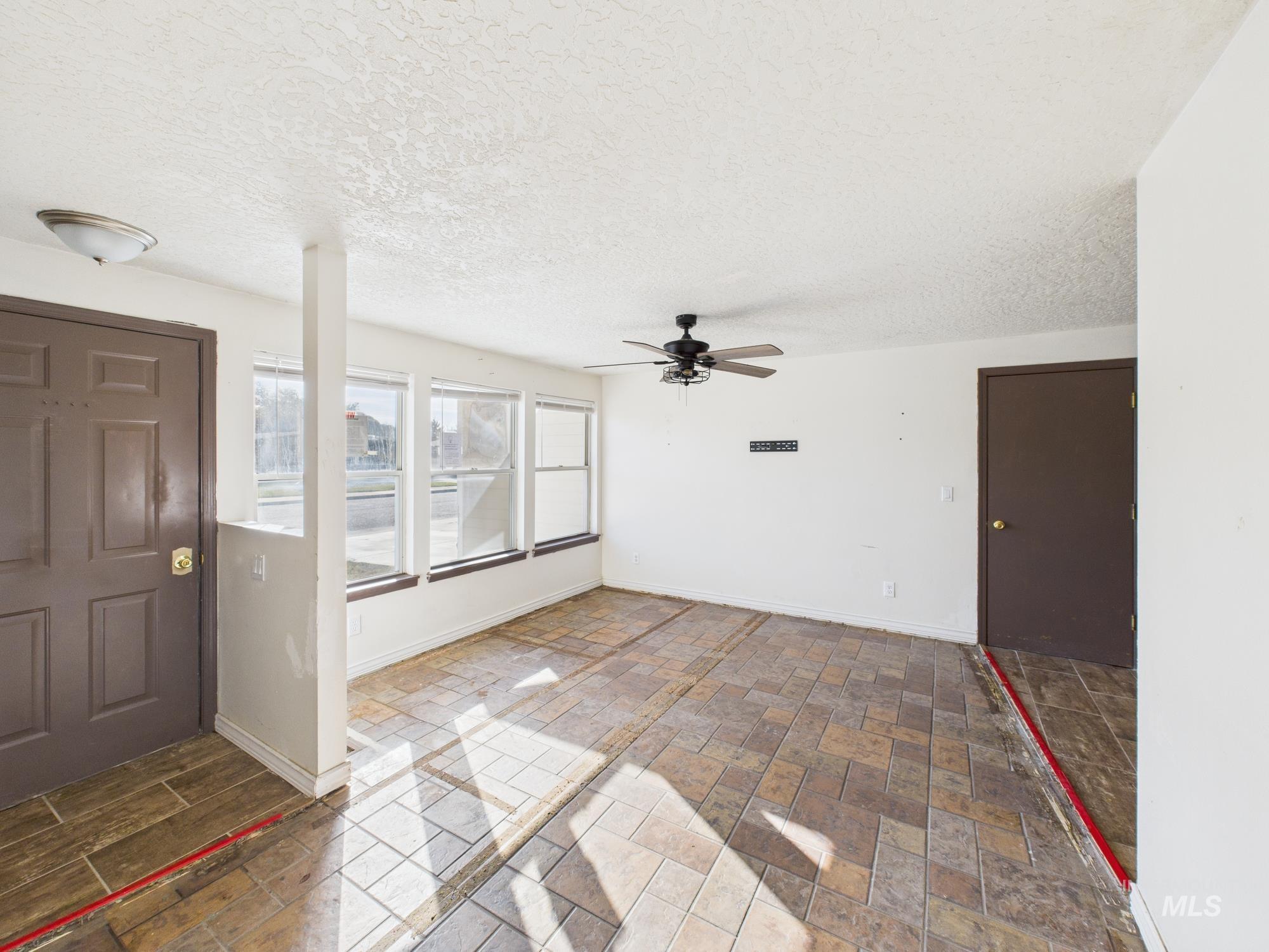Foyer with a textured ceiling and ceiling fan