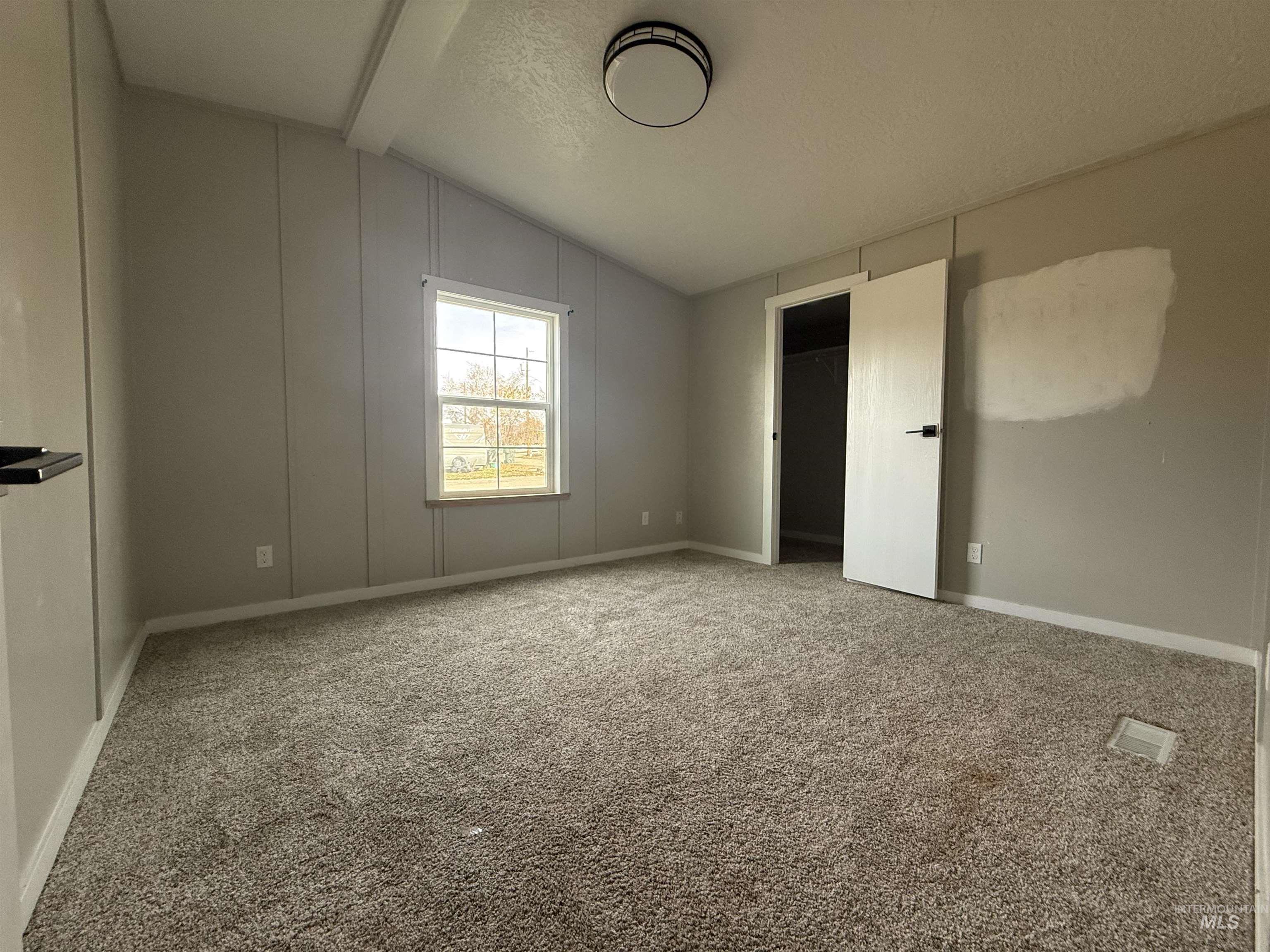 Spare room featuring carpet flooring and a textured ceiling
