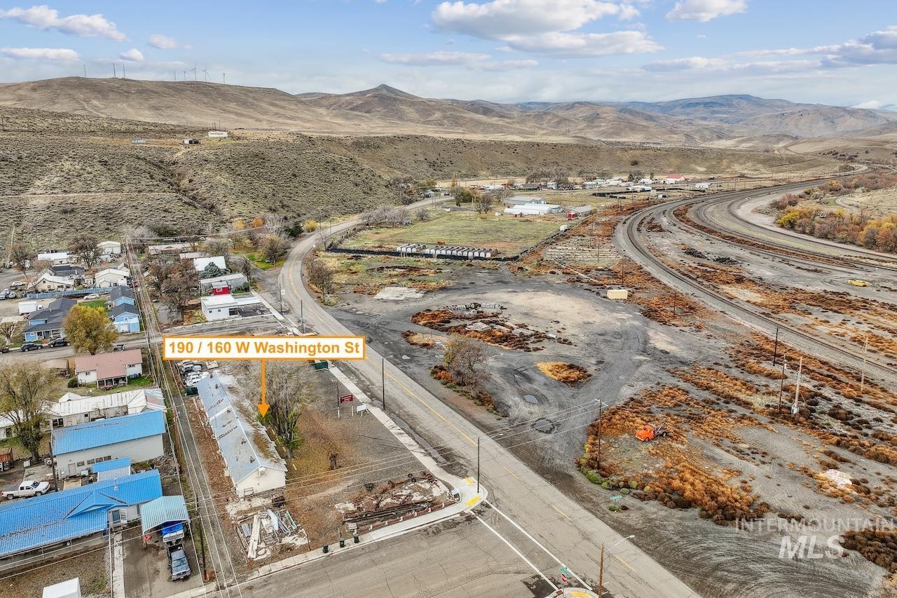 Aerial view of property's location with a mountain backdrop